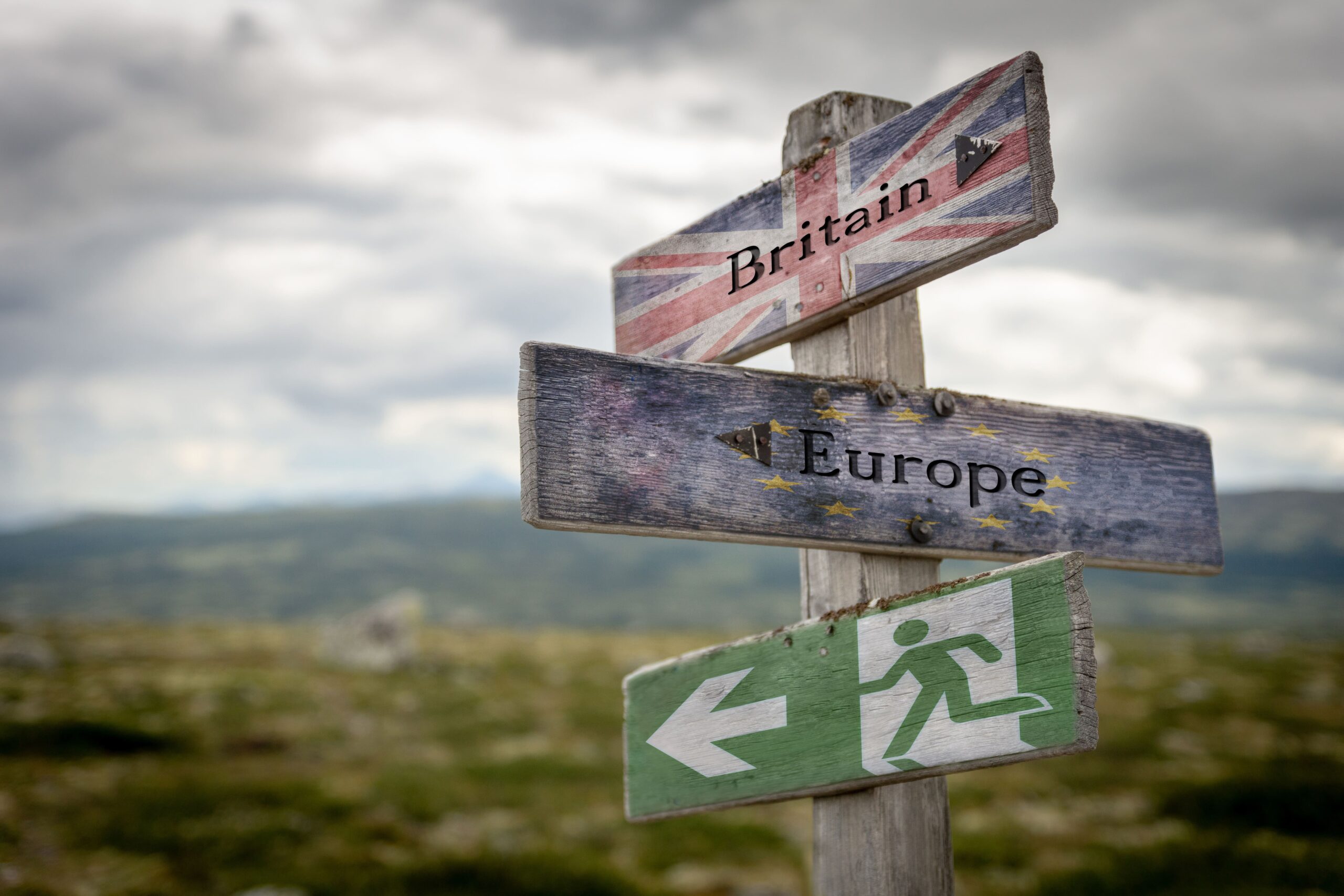 Sign pointing towards Britain, and another pointing towards Europe as a symbol of Brexit