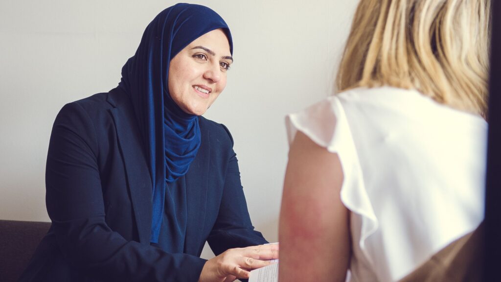 Azmi Quraishe, Litigation Solicitor, in a meeting with a client