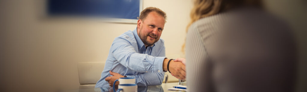 Ben Ironmonger, Commercial Healthcare Solicitor, in a meeting with a client