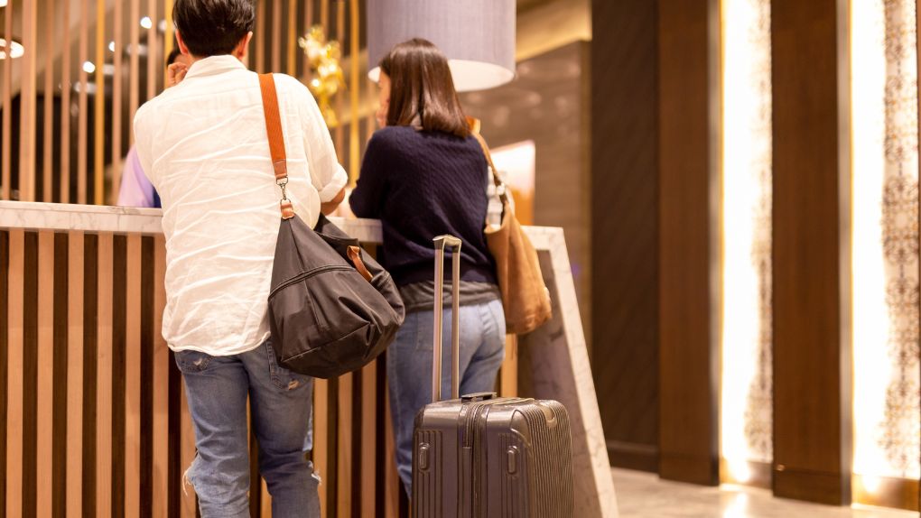 A couple checking in to a hotel