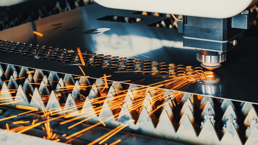A laser machine cutting metal in a manufacturing environment